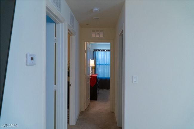Hall with visible vents and light colored carpet | Image 58