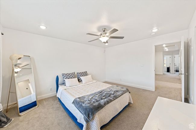 Bedroom featuring light carpet, ceiling fan, attic access, and recessed lighting | Image 19