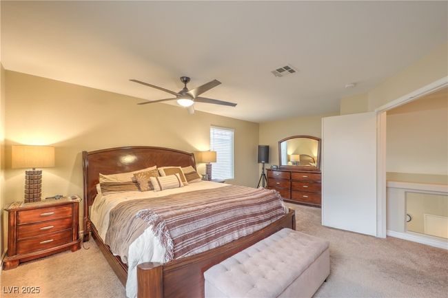 Bedroom featuring light colored carpet and ceiling fan | Image 18