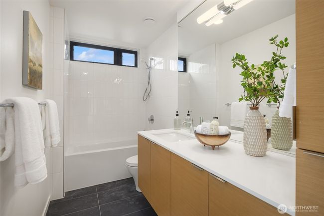 The full bath upstairs maintains the same consistent level of luxury and features a tub for soaking and relaxing after a long day, providing a luxurious and rejuvenating space. | Image 19