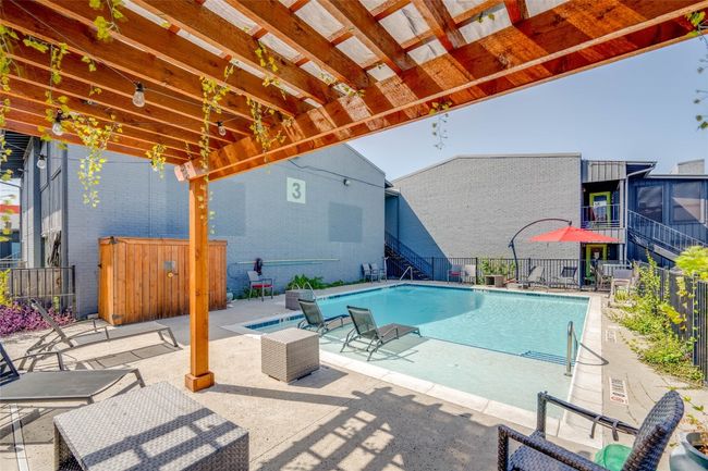 Community pool with a patio area and stairway | Image 28
