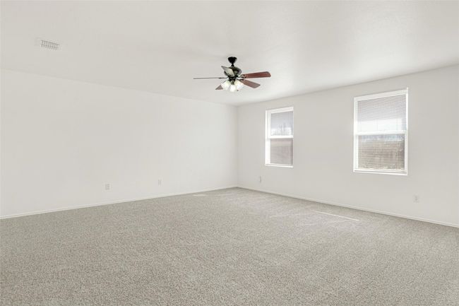 Empty room with ceiling fan, light carpet, and baseboards | Image 24