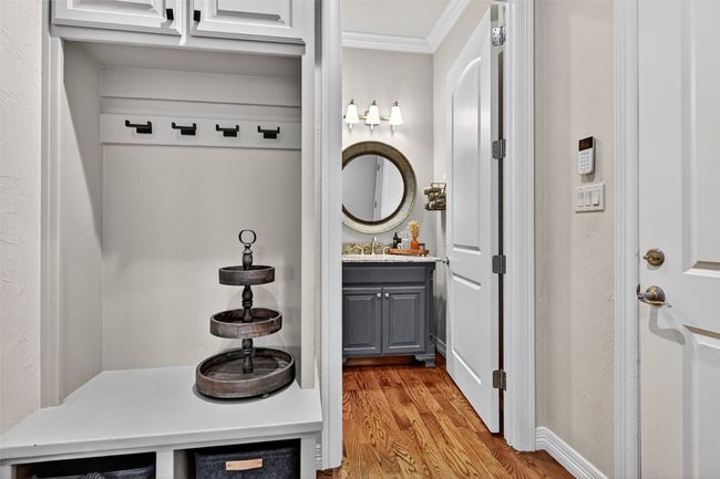 Mudroom featuring crown molding and wood finished floors | Image 17
