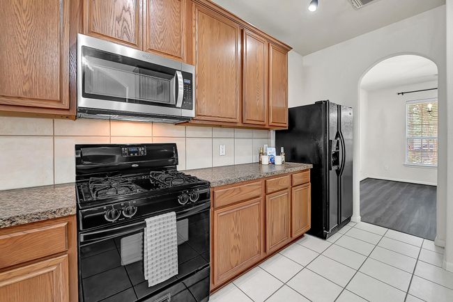 Kitchen view looking towards the dining room. The pantry is just behind the white door in the kitchen. | Image 8