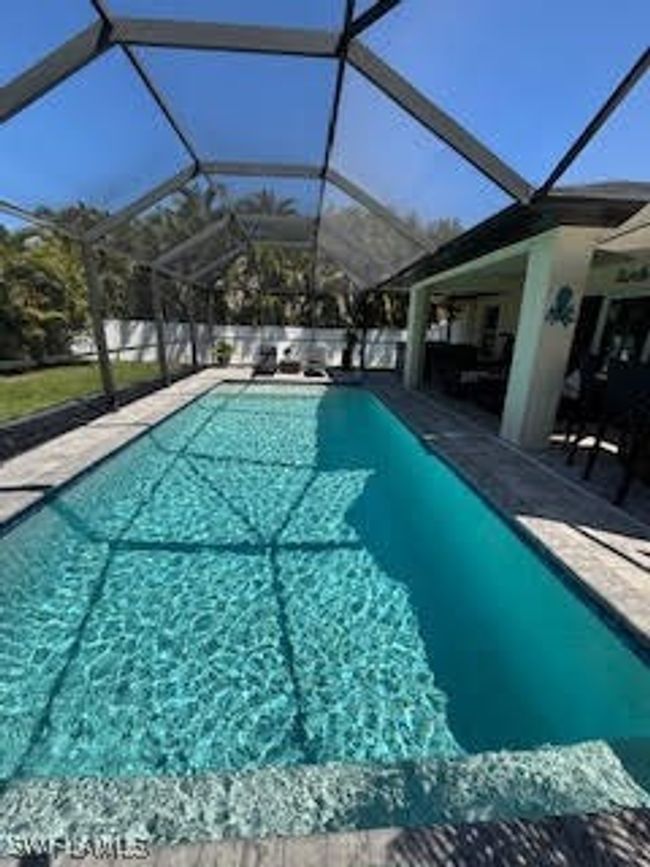 Pool featuring glass enclosure and a patio | Image 28