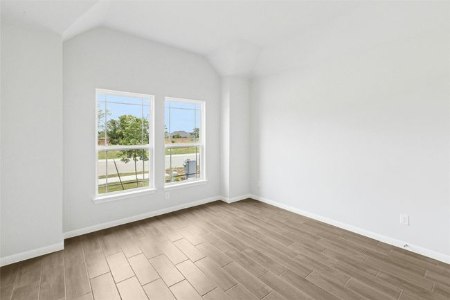 Additional living space with wood finished floors, baseboards, and vaulted ceiling | Image 17