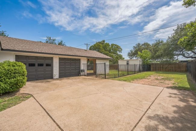 Two garage doors and additional parking for boat or RV | Image 30