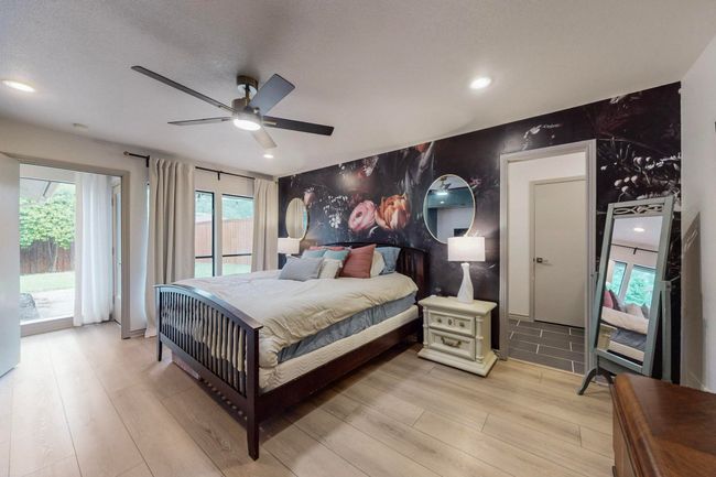 Master Bedroom with recessed lighting, light wood-style floors, access to exterior, ceiling fan, and an accent wall | Image 18