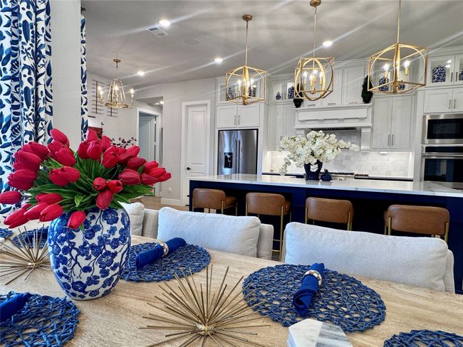 Kitchen featuring stainless steel appliances, a chandelier, light countertops, recessed lighting, and tasteful backsplash | Image 15