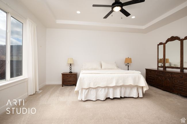 Carpeted bedroom featuring a raised ceiling and ceiling fan | Image 20