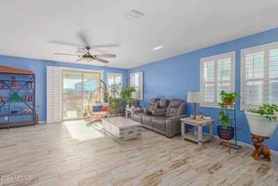 Spacious great room with plantation shutters and large slider to the rear covered patio | Image 3