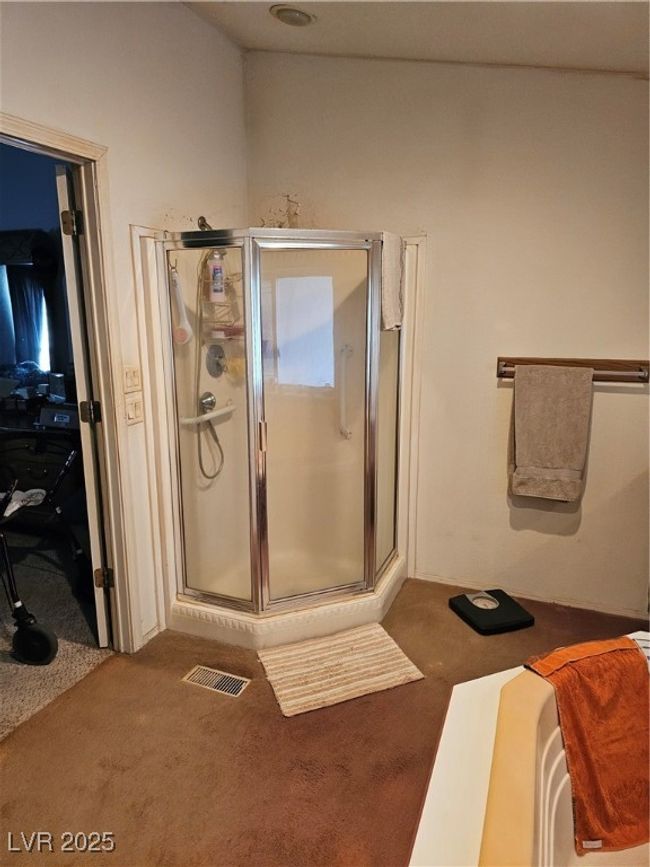 Bathroom featuring a shower stall and visible vents | Image 17