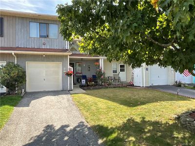 View of front of home featuring a garage and a front lawn | Image 1