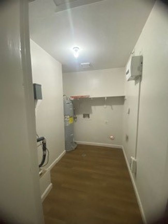Laundry room featuring wood finished floors, water heater | Image 15