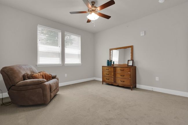 Bedroom #2 featuring baseboards, a ceiling fan, and light colored carpet | Image 14