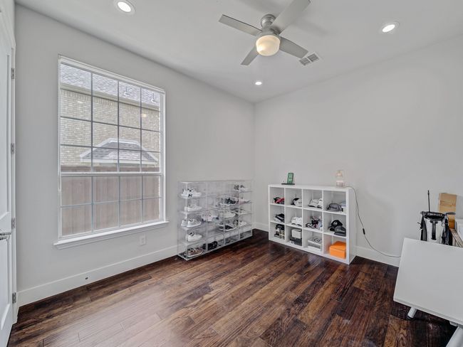 1st floor Spare room featuring wood finished floors, ceiling fan, baseboards, and recessed lighting | Image 15