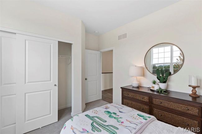 Bedroom featuring a closet and light carpet | Image 6