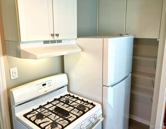 Eat-in kitchen comes with five burner gas stove, new refrigerator & new portable dishwasher + new vinyl flooring. | Image 7