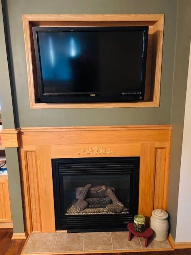 Room details featuring wood finished floors and a fireplace | Image 8