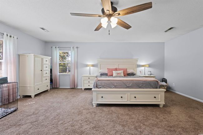 Bedroom with carpet flooring, baseboards, ceiling fan, and a textured ceiling | Image 12