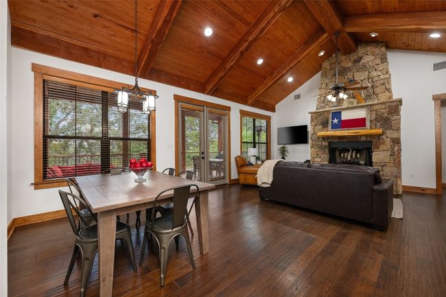 The open layout flows effortlessly from the dining area to the living room. Wood window and door casings add to the rustic charm. | Image 11
