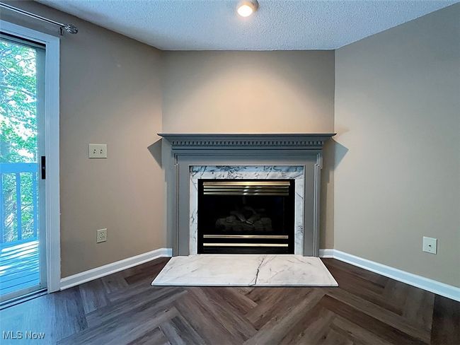 Detailed view of a fireplace and leading out to​​‌​​​​‌​​‌‌​‌‌​​​‌‌​​‌‌​‌​​​​​‌ balcony | Image 5