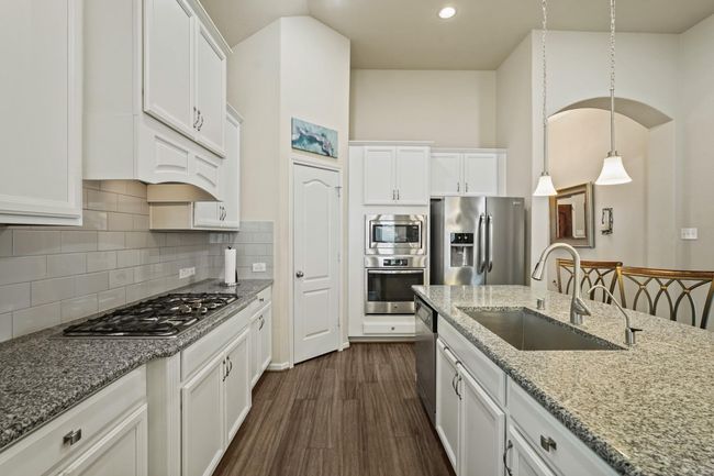This versatile home offers endless potential: a spacious living area opening to a patio, a kitchen ready for gourmet upgrades, adaptable bedrooms for rest or work, and bathrooms primed for a luxurious, modern transformation. | Image 9