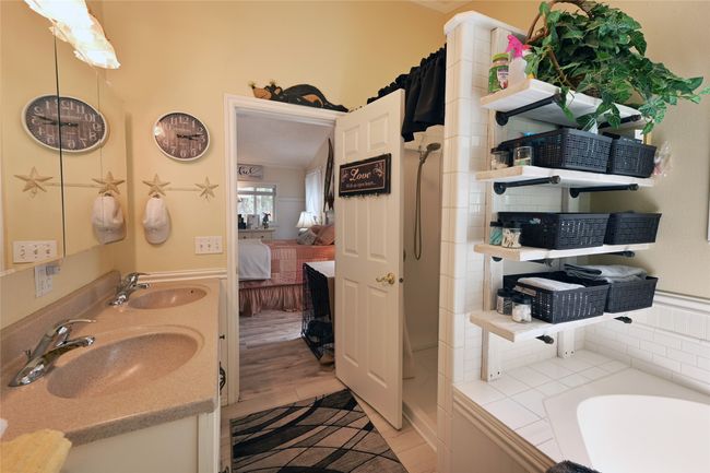 Ensuite bathroom featuring a garden tub and double vanity | Image 34