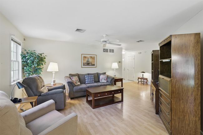 Living room with ceiling fan & laminate flooring | Image 5