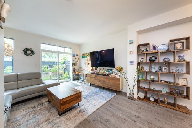 Living area with wood finished floors and baseboards | Image 5