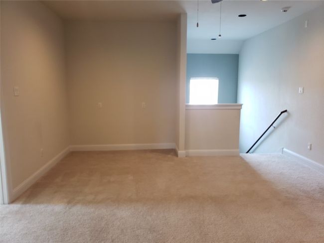 Empty room with light carpet and attic access | Image 9