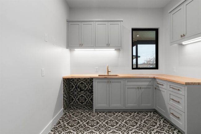 Featuring a generous layout and a convenient sink, this laundry room combines practicality with plenty of space, ensuring you have everything you need to stay organized and efficient | Image 16