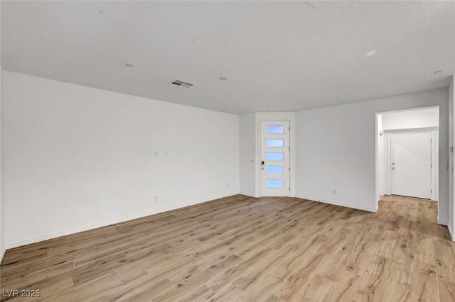 Unfurnished room with visible vents, light wood-style flooring, and baseboards | Image 8
