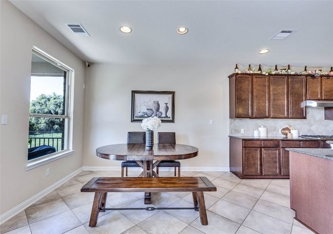 Spacious breakfast area with view to greenbelt and backyard. | Image 9