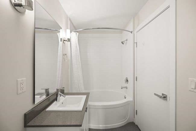 Bathroom with vanity and shower / tub combo with curtain | Image 18