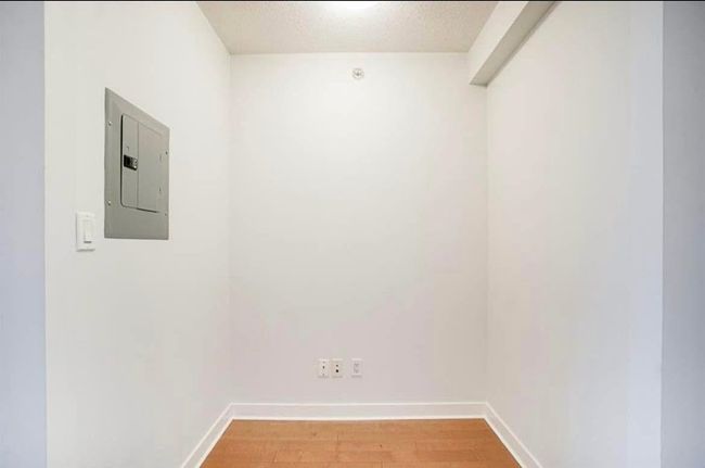 Unfurnished room with light wood-type flooring, electric panel, and baseboards | Image 12