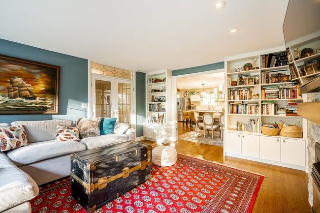 Living area featuring french doors, wood finished floors, and a chandelier | Image 12