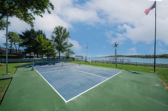 View of tennis court featuring a water view | Image 26