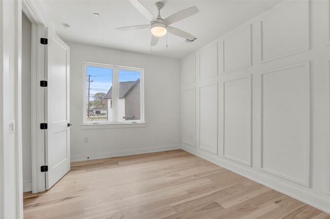 Unfurnished bedroom with light wood finished floors, baseboards, and ceiling fan | Image 24