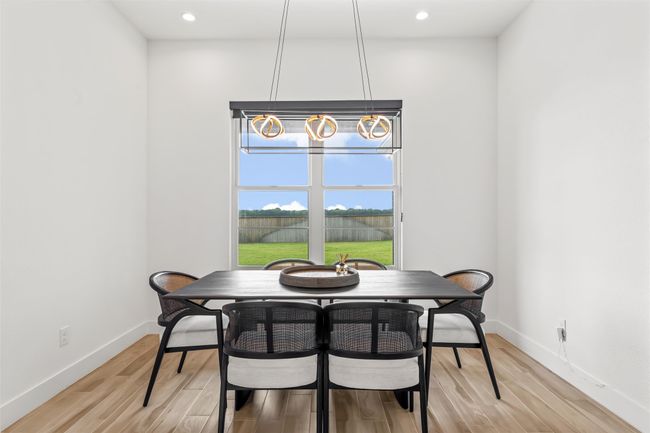 Dining area with baseboards, an inviting chandelier, and light wood-style floors | Image 17