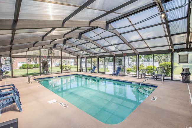Indoor community pool with a patio area and a lanai | Image 22
