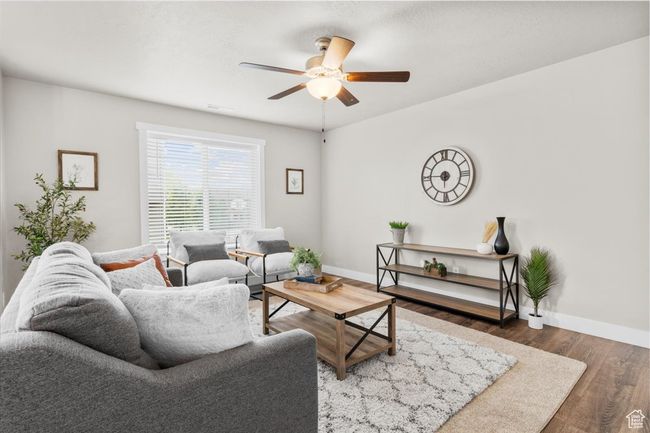 Living area featuring ceiling fan, wood finished floors, and baseboards | Image 12