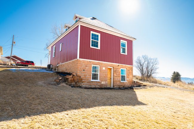 View of property exterior featuring a shingled roof and central AC | Image 31