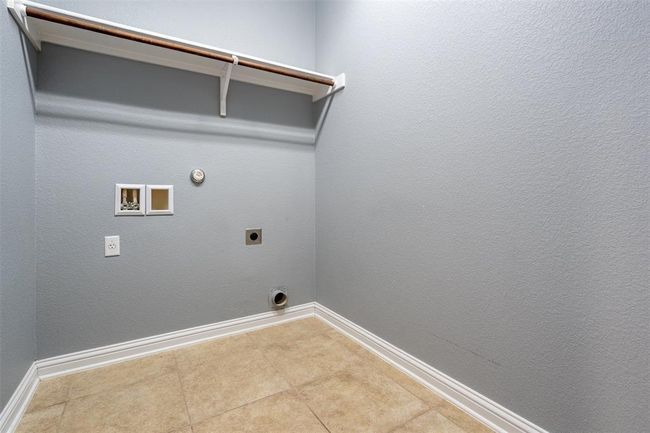 Laundry room featuring electric dryer hookup, gas dryer hookup, washer hookup, and tile patterned floors | Image 20