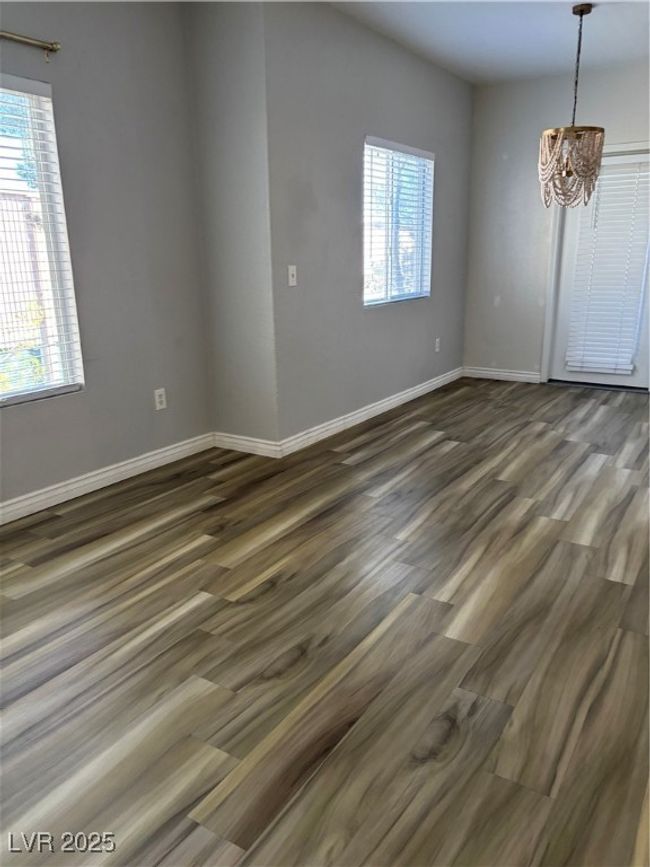 Unfurnished room featuring dark wood-type flooring and baseboards | Image 8