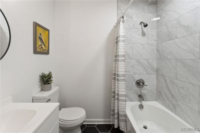 Full bathroom featuring vanity, toilet, tile patterned flooring, and shower / bath combination with curtain | Image 3