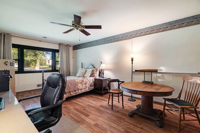 Bedroom featuring wood finished floors and baseboards | Image 21