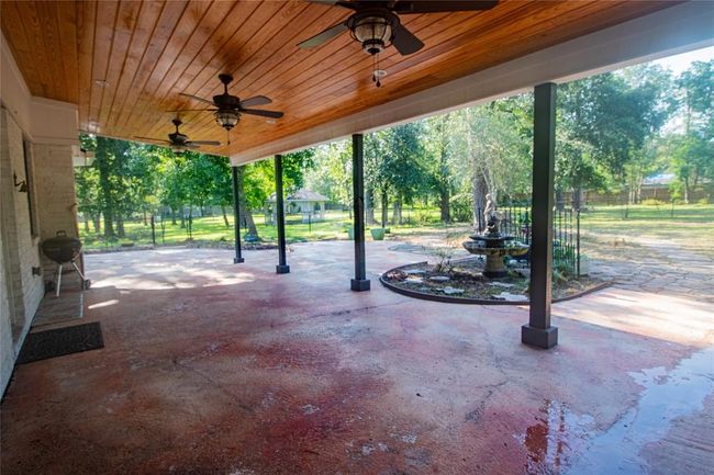 Covered rear area. Fans again to cool down and enjoy watching the deer. The gazebo can be seen in the middle of the photo. | Image 38