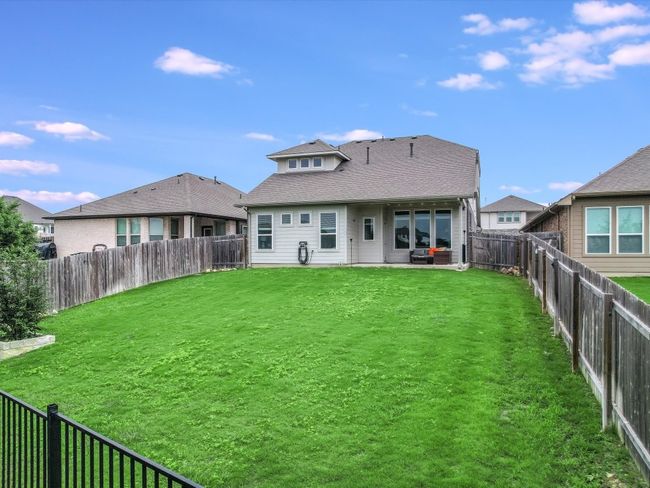 Wrought iron fencing at the back and wood privacy on the sides | Image 26