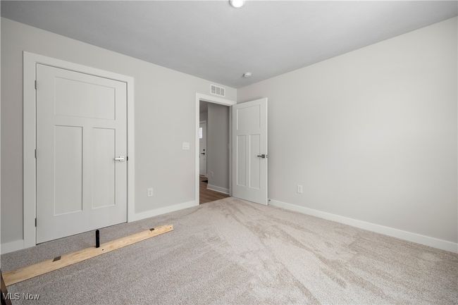 bedroom featuring carpet floors, baseboards, and visible vents | Image 13